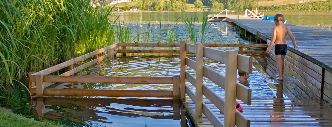 Child jumps into Holc natural pool built into a lake - Benefits