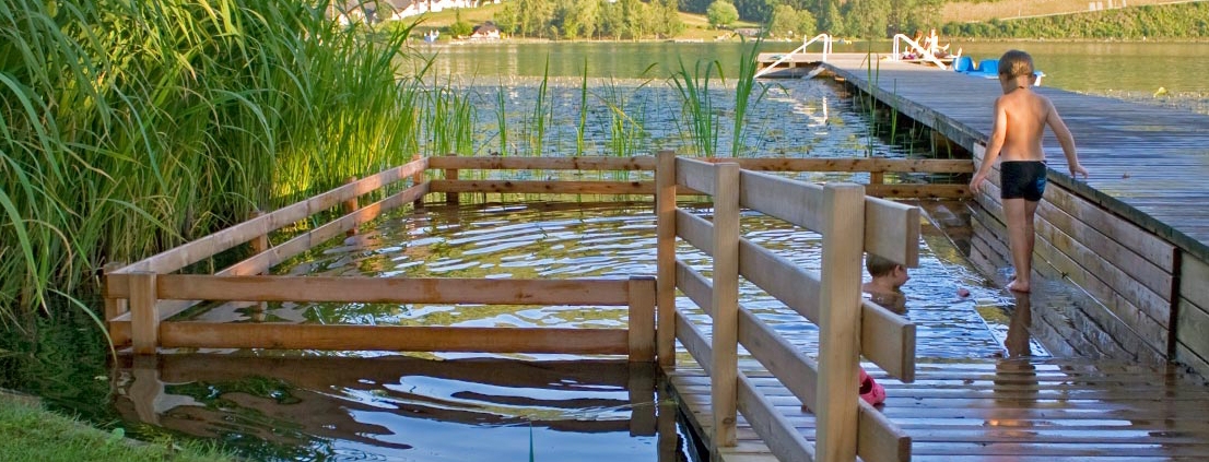 Child jumps into Holc natural pool built into a lake - Benefits