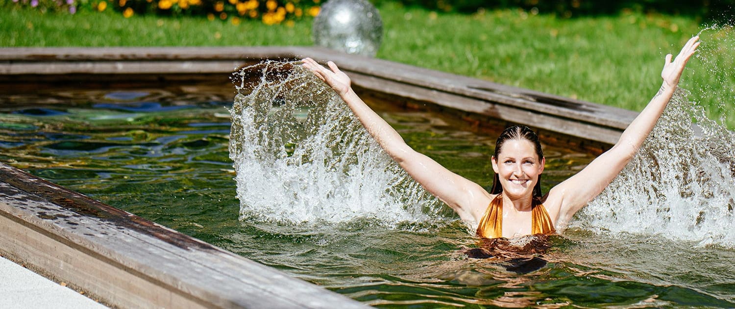 Showing a lady in the Holc Natural Pool