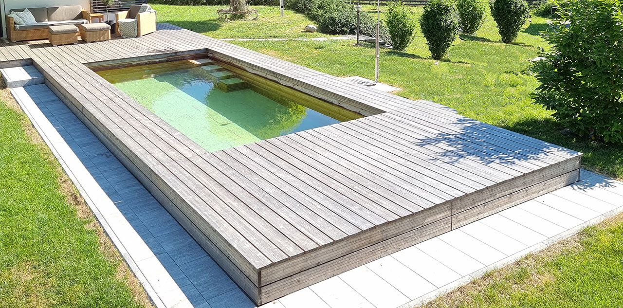 Crystal clear water in the natural pool made of wood with stone floor